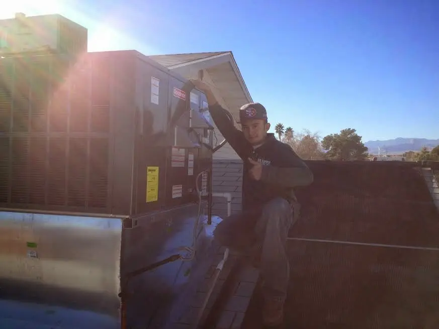 HVAC technician performing AC Tune-Up on a rooftop unit in Hiram